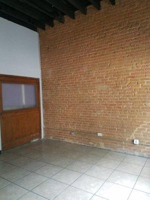 Exposed Brick Wall With Plenty of Outlets For Displays