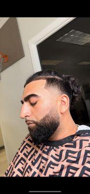 Mid taper with precision beard line, fade and sculpting.