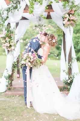 A kiss to last a lifetime at our wedding pergola under the Oak tree.