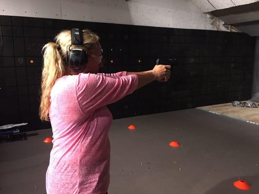 A concealed carry student successfully shoots her qualification.