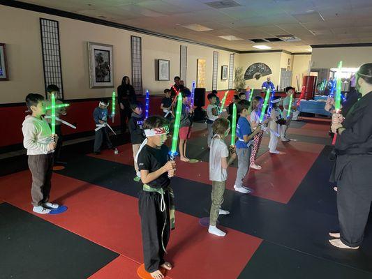 Birthday party, lightsaber training.