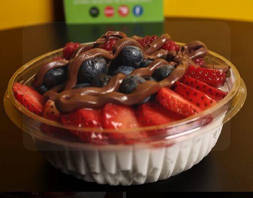 Coconut Bowl topped with Strawberries, Blueberries, Raspberries & Nutella.