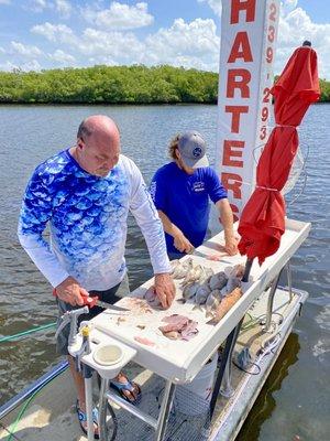 Captain Joey D and our captain for the day, Nick, filleting our catch.