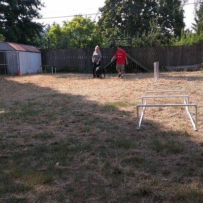 Leash training in the back field with Paul and my mom, Lana.