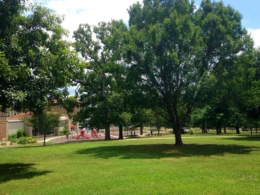 Large grassy areas with shade trees