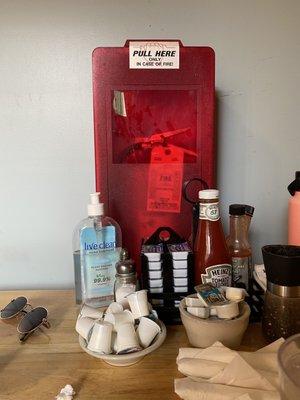 Oddly placed table next to fire extinguisher