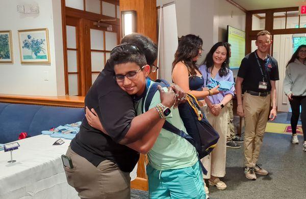 Returner camper reuniting with his instructor from the previous year.