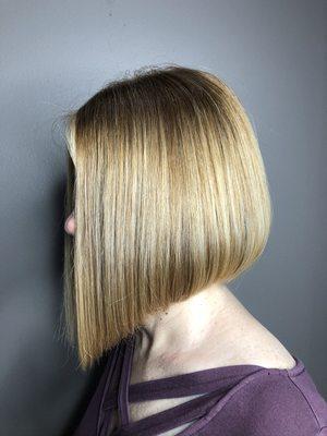 I did an Extreme angled Bob with a natural tone to cover up her grays with a soft touch of accent fouls around her face!