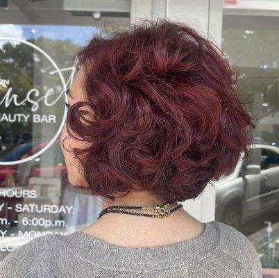 Embrace the sizzling allure of wavy short red hair, igniting a bold and vibrant statement that demands attention.