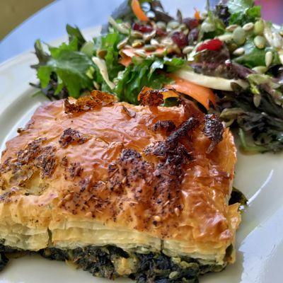 Spanakopita is a Greek savory spinach pie. It contains cheese, typically feta and a side of delicious salad. So good!