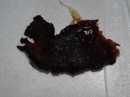 photo 3: super burnt piece of brisket taken from the sandwich in my $20 meal.