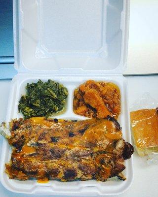 Delicious Rib Dinner with sizes of collard greens and candy yams , also cornbread.