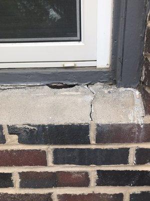 Cracked concrete casing around the window.  Water could seep into the house when it rained.