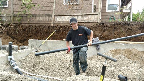 One of our apprentices working on some underground plumbing