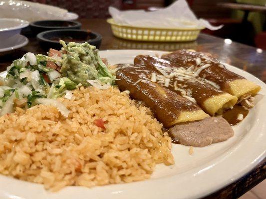 Three corn enchiladas (beans, cheese, & chicken) with guac salad and rice.