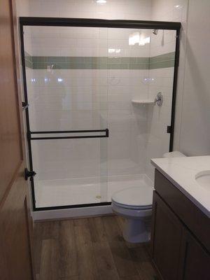 Sliding shower door with clear glass and black metal. Hilton Glass and Door 208-263-3322