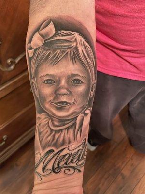 Photo tattoo of my daughter when she was a wee one.