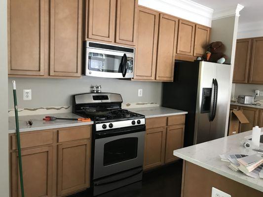 Before picture of a kitchen in a new home with basic cabinets.