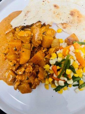 Butter chicken and potatoes with garlic Naan Bread.