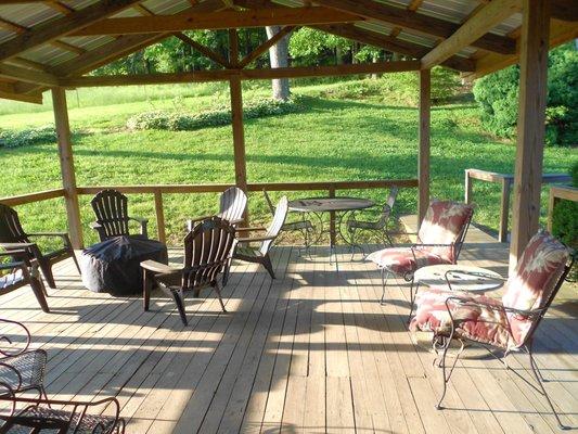 Soft breeze, green trees, chaise lounge, gas grill, table seating for 10 ... and privacy! Check out the back deck ...