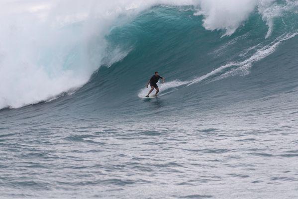 Tow in session at an outer reef on the north shore