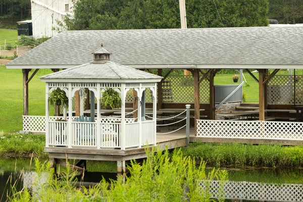 Small little gazebo out over part of the pond.