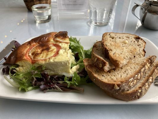 A slice of tomato quiche and whole wheat bread. You could also have a side salad.