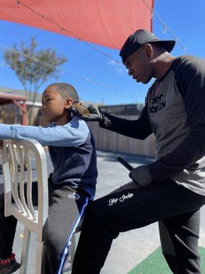 JocTheBarber cutting hair outside on a beautiful spring day!