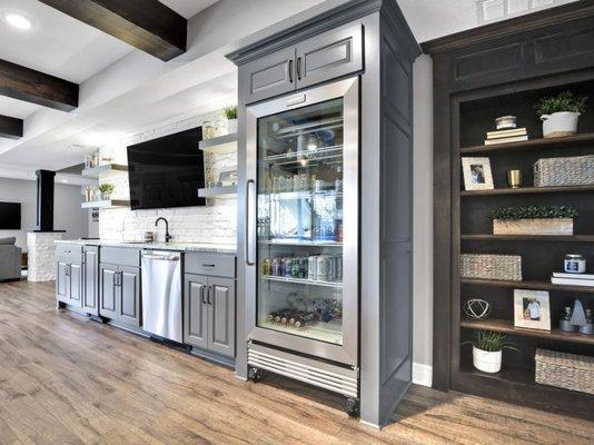 Custom cabinetry includes hidden room behind bookcase "door".