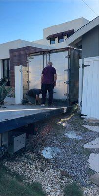 Mike and team removing shipping container from tight side yard