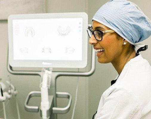 Dr. Marwa Forest smiling while talking to a patient in the Edina, MN office.