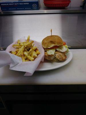 Grilled chicken breast on a roll with lettuce and tomatoe