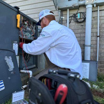 Petitt Heating & Cooling HVAC technician working on unit