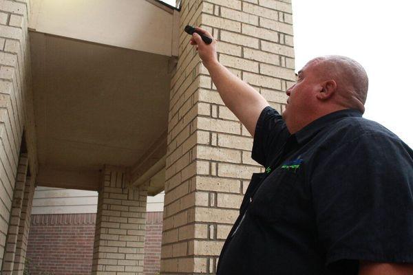 Greg inspecting exterior of home