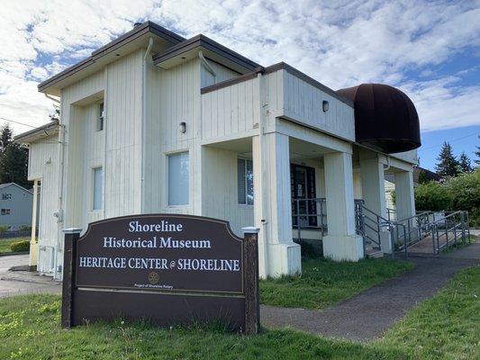 Main building with exhibits and sign visible from the road.