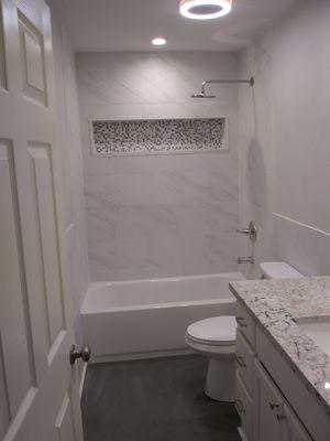 custom hall bath, new tub, fixtures, tile, flooring and granite. Re-furbished existing vanity and painted all white. Tile inset looks great!