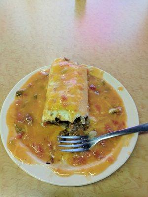 Egg, potato, and sausage burrito smothered. $6