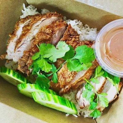 Fried Khao Mun Gai: Thai styled fried chicken served with sweet chili sauce, steamed ginger rice, cucumber and cilantro.