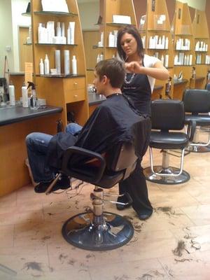 Emily cutting Tom's hair.