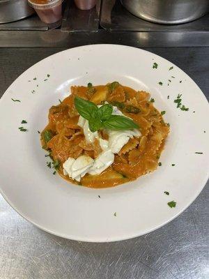 Farfalle with Pepper Vodka Sauce: Bowtie pasta in cream sauce with a touch of tomato, zucchini, asparagus, melted mozzarella