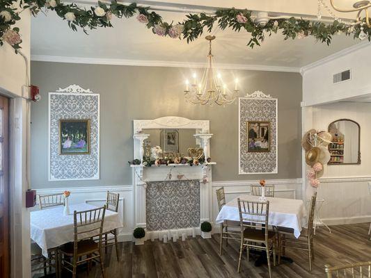 Our lovely, newly restored front of tearoom with antique fireplace surround, wainscoting, damask moldings, and more!