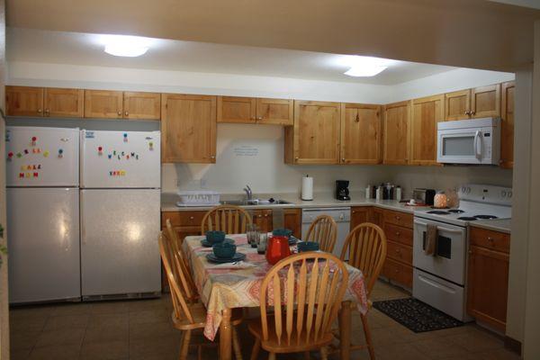 Double refrigerator kitchen stocked with all your cooking supplies.