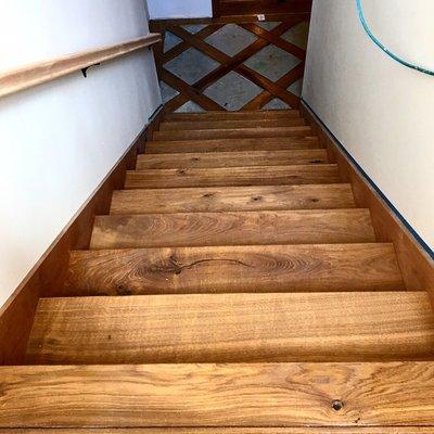 Stair installation with a tile/ hardwood basket weave pattern.