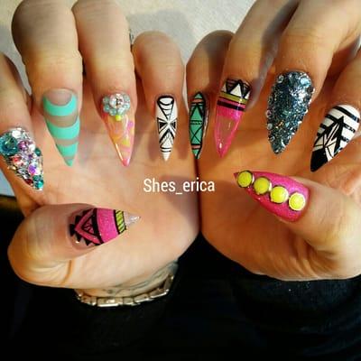 Stiletto nails with freestyle hand painted designs.