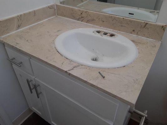 Bathroom counter and sink before the refinishing with multi-speck