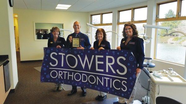 Dr. Stowers with his staff, recieving his BEST ORTHODONTIST IN LOVELAND AWARD.