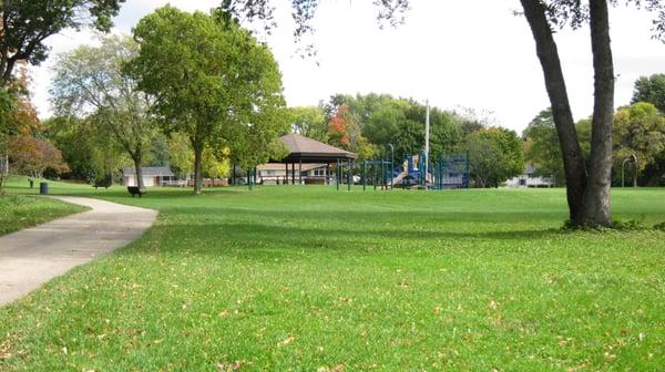 A view of the playground equipment and the shelter house