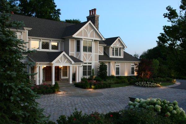 Classic cobblestone visitor courtyard with lush foundation garden.