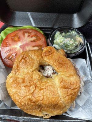 Chicken salad on a croissant with broccoli salad