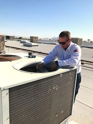 Performing a preventative maintenance on a commercial unit. Call us today to find out why it's important to service your units year round.